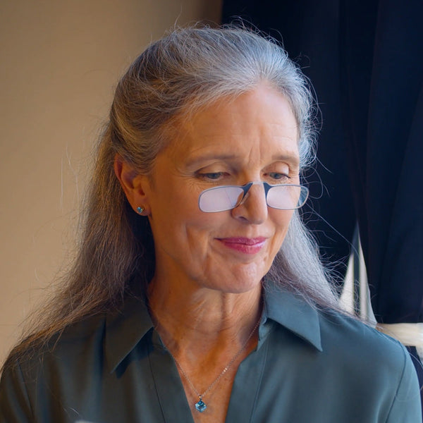 Woman in restaurant wearing Blue ThinOptics Readers